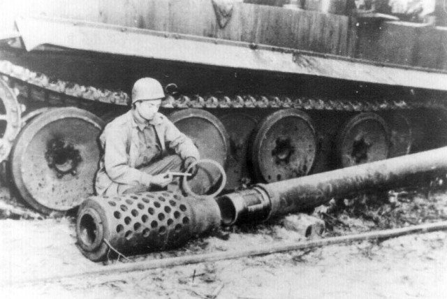 Allied soldier inspecting the 12.8 KwK gun to be mounted on the E-100