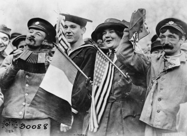 Armistice Day Celebrations, Paris, 11 November 1918 An American sailor, an American Red Cross Nurse and two British soldiers celebrating the signing of the Armistice, near the Paris Gate at Vincennes, Paris.