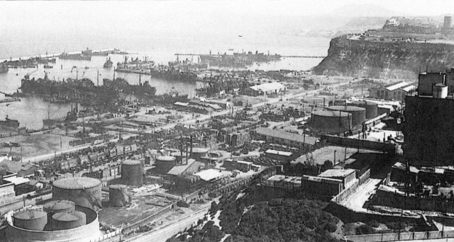 Oran harbor. In Operation RESERVIST, the British cutters Walney and Hartland carried hundreds of American soldiers into the teeth of French defenses before dawn on November 8. The port entrance is visible in the upper center of this photograph, taken six months later.