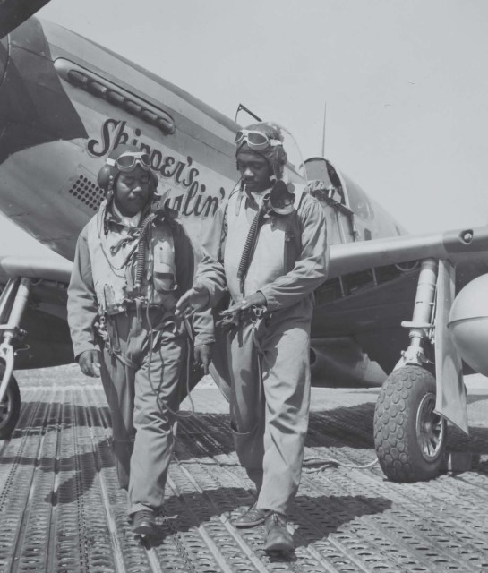 Tuskegee Airmen Capt. Andrew Turner and Lt. Clarence “Lucky” Lester of the 332nd Fighter Group discuss tactics near P-51C Skipper’s Darlin’ III in Italy in 1944. At the time, Lester had shot down three German airplanes in air-to-air combat. National Archives