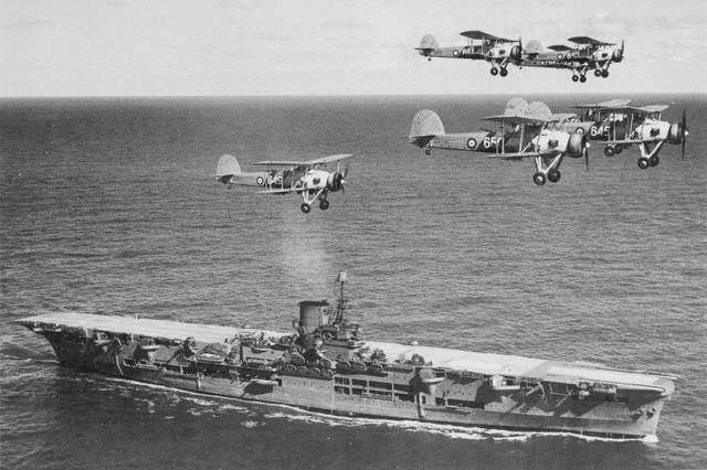 HMS Ark Royal in 1939, with Swordfish of 820 Naval Air Squadron passing overhead