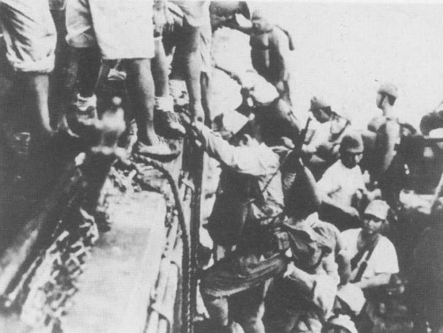 Japanese troops load onto a warship in preparation for a Tokyo Express run sometime in 1942.