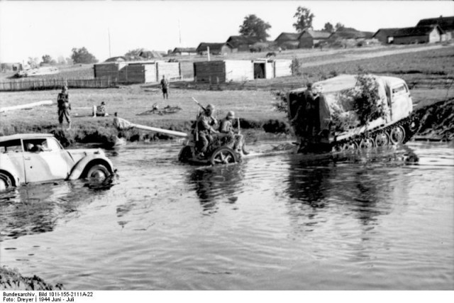 Raupenschlepper Ost hauls an artillery gun across a river, 1944