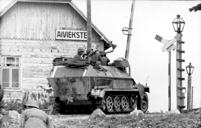 German armored fighting vehicle Sd.Kfz.251 in some city in Latvia. June 1941