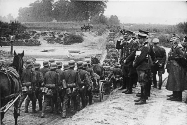 Hitler watching German soldiers marching into Poland in September 1939.