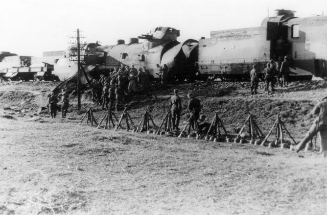 A damaged Polish armored train captured by German Leibstandarte SS Adolf Hitler regiment, near Blonie, Poland. September 1939 [U[United States Library of Congress | Public Domain]<figcaption class=