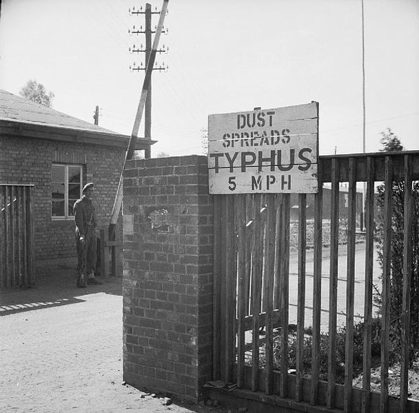 A sign at the entrance of Bergen-Belsen to try and stop the spread of dust carrying the lice that were spreading typhus. Wikimedia Commons / Public Domain.