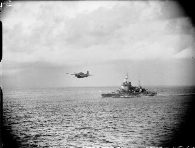 A Grumman Martlet of the Fleet Air Arm flying over HMS Warspite during the Madagascar operations.