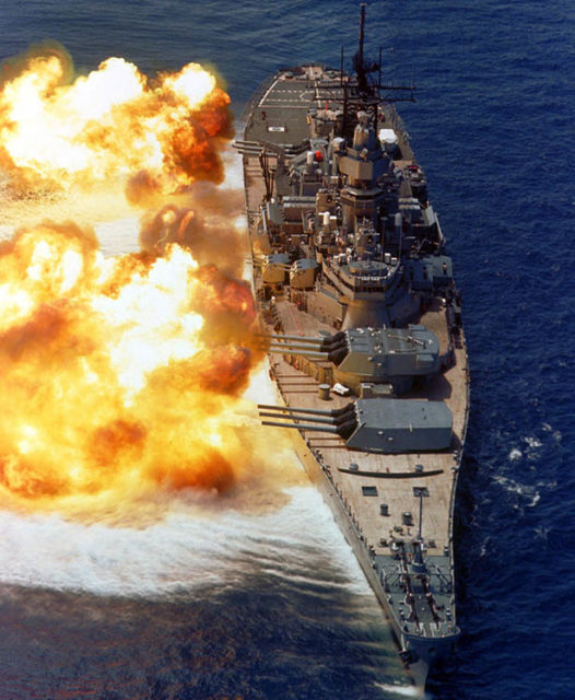 Photo of USS Iowa firing a broadside.