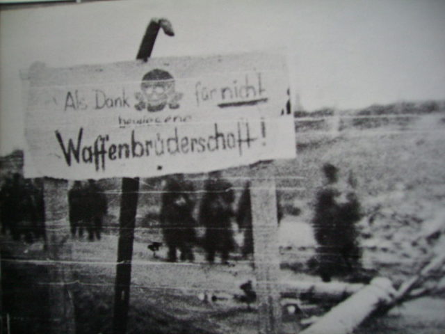 Germans put up a sign that reads “as thanks for not demonstrating a brotherhood of arms”