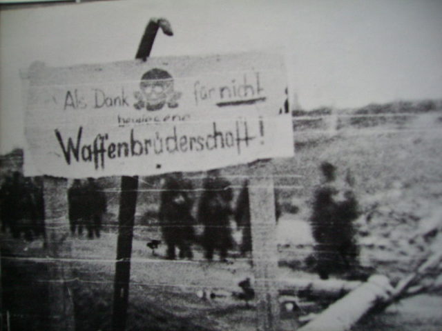Germans put up a sign that reads “as thanks for not demonstrating a brotherhood of arms”