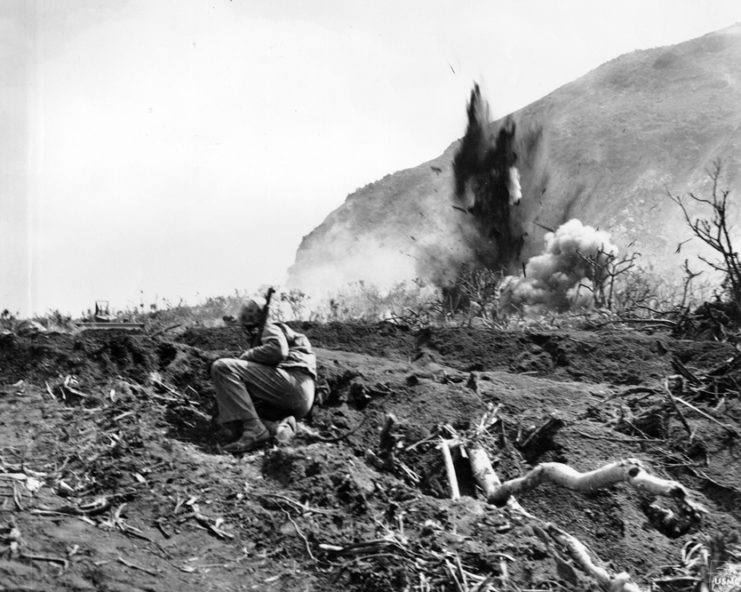 Iwo Jima, February 24, 1945. Scratch One Jap Position: A Japanese position at the base of Mount Suribachi is eliminated by a high explosive charge set off by the invading Marines. By USMC Archives CC BY 2.0