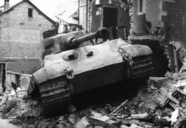 When King Tiger 105, commanded by SS-Obersturmführer Jürgen Wessel, was struck by bazooka fire, the driver reversed into the debris of a house and got stuck. The crew abandoned the tank on Rue St. Emilion in Stavelot, Belgium. Wessell jumped on the next tank and continued west towards Trois Ponts.