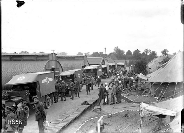 A convoy of six ambulances carrying World War I wounded soldiers readies to leave the New Zealand Stationary Hospital in Wisques, France, for the ambulance train to England.