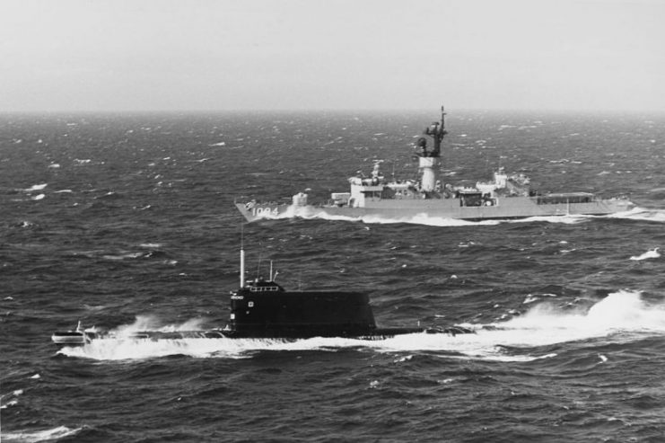 A Soviet Project 629A-class (NATO reporting code “Golf II”) ballistic missile submarine underway off Denmark, near Copenhagen, with the U.S. Navy frigate USS Pharris (FF-1094) in attendance, 10 June 1978. The two ships encountered each other while the submarine was transiting the Baltic Sea, and the frigate was operating with the Standing Naval Force Atlantic.