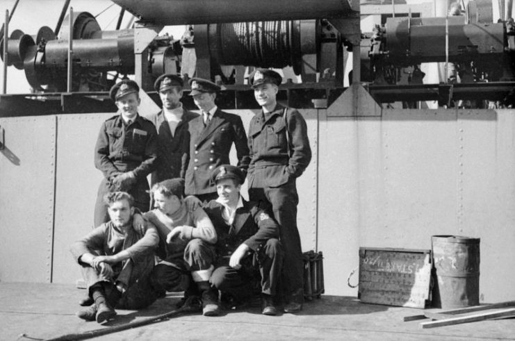 Lieutenant Henty-Creer, RNVR and the crew of X 5, one of the midget submarines that made a successful attack on the Tirpitz at Alten Fjord, on the deck of a ship.