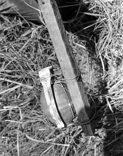 Improvised booby trap using a hand grenade.