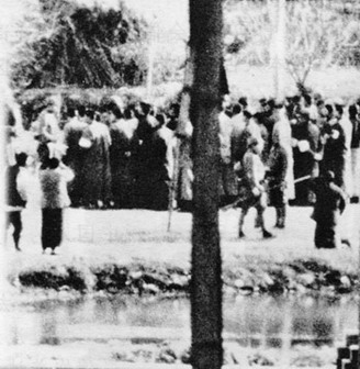 Chinese women on Shanghai Road, inside the Nanking Safety Zone, begging Japanese soldiers for the lives of their sons and husbands when they were being collected at random on the suspicion of being ex-soldiers. Thousands of civilians were taken in this way, carried to the river bank in Hsiakwan, to the edges of ponds, and to vacant spaces where they were killed.