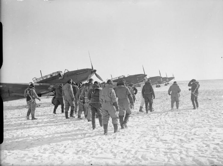 Royal Air Force- France, Fairey Battle aircrew walk to their aircraft on a snow-covered airfield.