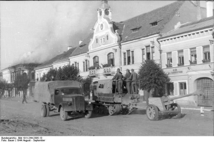 German Opel Blitz, a tracked vehicle, and a towed 7.5 cm PaK 40 gun. By Bundesarchiv – CC BY-SA 3.0 de