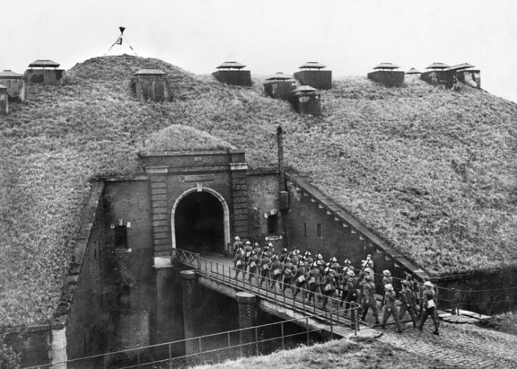 Troops of 51st Highland Division march over a drawbridge into Fort de Sainghain on the Maginot Line, 3 November 1939