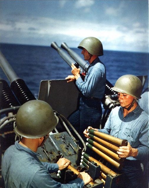 USS Alaska (CB-1): Crew of a 40mm quad antiaircraft machine gun mount loading clips into the loaders of the left pair of guns. Taken on 6 March 1945, during the Iwo Jima operation.