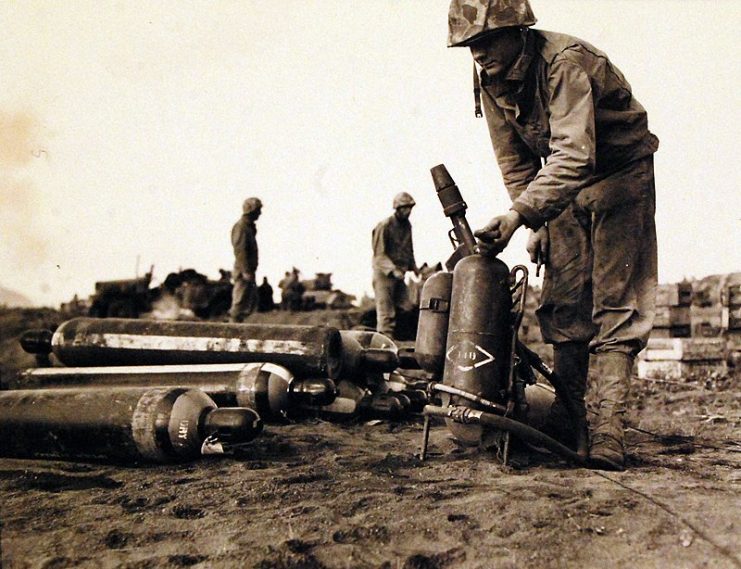 Between two airfields (Motoyama), Private First Class Thomas N. Brown, is refueling a flame thrower.