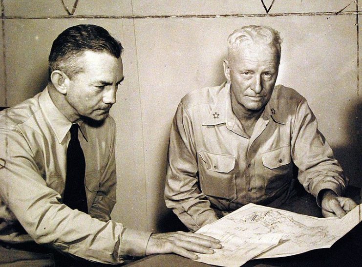 Secretary of the Navy James V. Forrestal, left, and Fleet Admiral C.W. Nimitz, USN, Commander in Chief, U.S. Pacific Fleet and Pacific Ocean Areas look over final plans for the invasion of Iwo Jima.