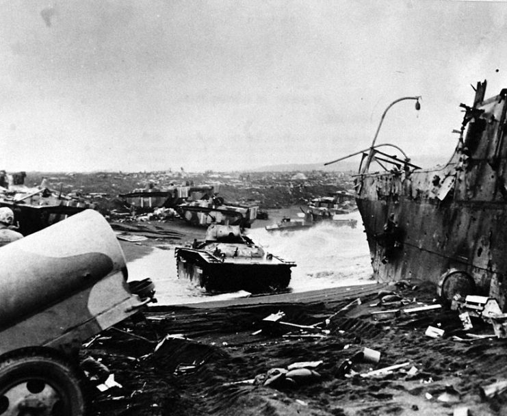 Wreckage of vehicles and ships on beach of Iwo Jima in Volcanic Islands on D-Day, from heavy fire by Japanese and U.S. Forces, February 19, 1945