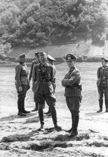 General Erwin Rommel and his staff observe troops of the 7th Panzer Division practicing a river crossing at the Moselle River in France in 1940. By Bundesarchiv Bild CC-BY-SA 3.0