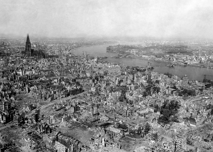 The Kölner Dom (Cologne Cathedral) stands seemingly undamaged (although having been directly hit several times and damaged severely) while entire area surrounding it is completely devastated. The Hauptbahnhof (Köln Central Station) and Hohenzollern Bridge lie damaged to the north and east of the cathedral. 1945.