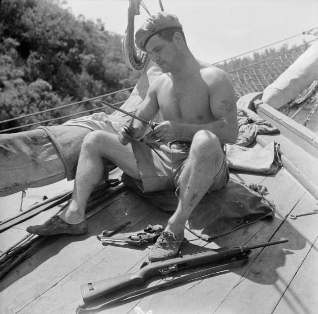 British Special Forces in the Aegean, 1944 Corporal Aubrey of the SBS (Special Boat Service) sharpens his fighting knife as he prepares for combat.