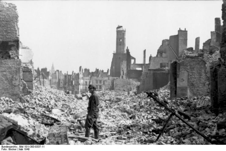 German soldier amidst the ruins of Calais, May 1940.