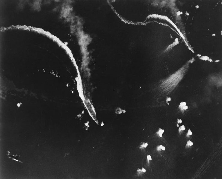 The Japanese aircraft carrier Zuikaku (left center) and (probably) the Japanese aircraft carrier Zuihō (right) under attack by U.S. Navy dive bombers during the Battle off Cape Engaño, 25 October 1944. Both ships appear to be making good speed, indicating that this photo was taken relatively early in the action.