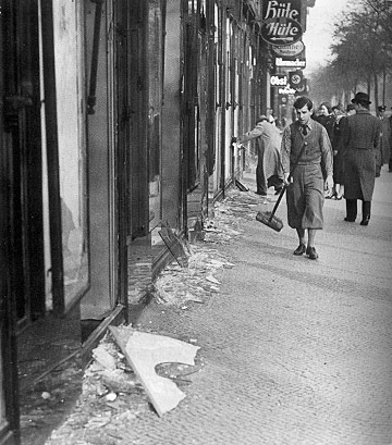 A boy cleans the street after Kristallnacht