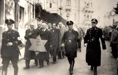Jews are being forced to walk with the star of David during the Kristallnacht in Nazi-Germany in the night of 9-10 November 1938