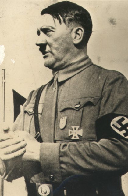 Hitler in his brownshirt SA uniform wearing the Nuremberg Party Day Badge and his World War I Iron Cross
