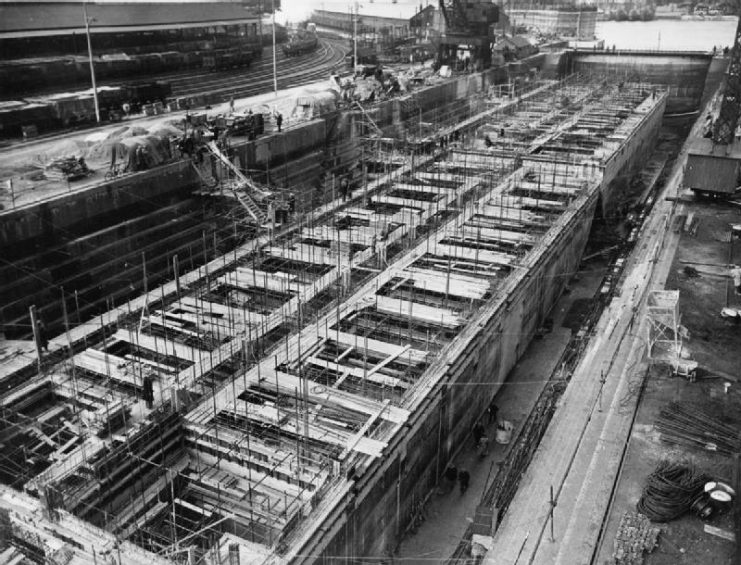 Construction of Mulberry Harbours, Southampton, April 1944.Concrete caissons (Phoenixes), to be used as breakwaters, under construction in dry dock.