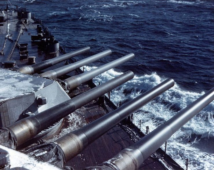 Ship’s forward 16/45 guns train to starboard during a North Atlantic battle practice. Photographed during her shakedown period, circa December 1942 – January 1943