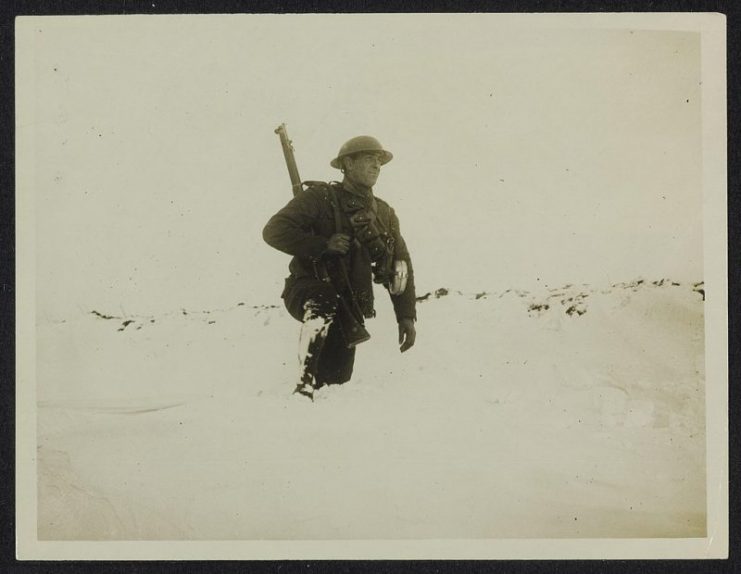 British Tommy tests the depth .. a drift of snow.