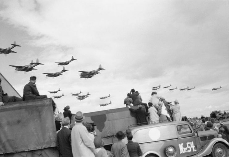 Danish civilians watch a fly-past of De Havilland Mosquitos of No. 2 Group at Copenhagen airport, during an air display given by the RAF in aid of the liberated countries.