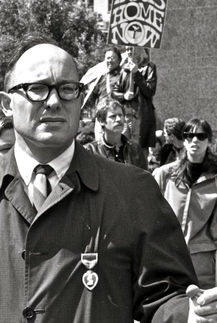 Man wearing Purple Heart medal during Vietnam peace march, 1967.