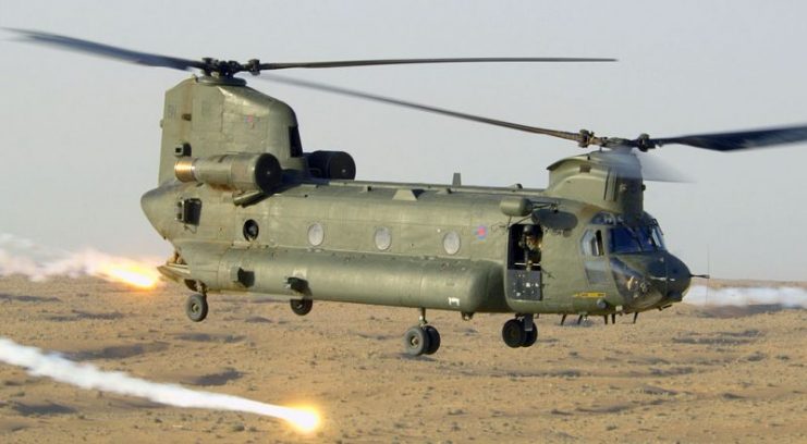 A Chinook CH47 helicopter, ZA718 Bravo November, releases decoy flares whilst flying over the desert in Afghanistan in support of British troops in Helmand province. Photo: POA(Phot) Sean Clee/MOD OGL v1.0