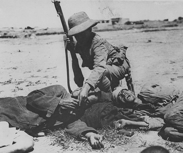 British soldier giving a starving Turkish soldier a biscuit during the Mesopotamian campaign