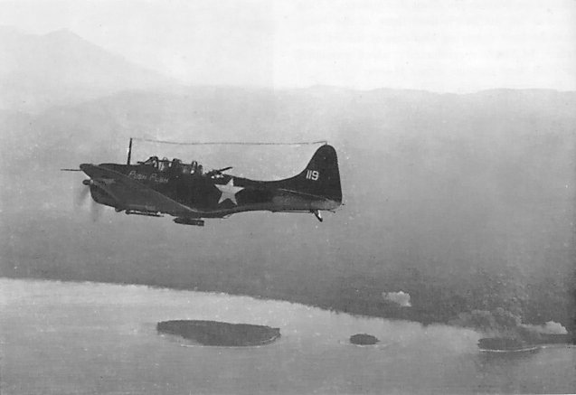 SBD Dauntless dive bomber of US Marine Corps VMSB-144 squadron flying over Cape Torokina by Empress Augusta Bay, Bougainville, Solomon Islands, 1 Nov 1943