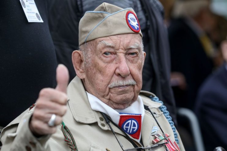 US veteran Raymond Wallace gestures as he arrives to take part in the “Carre de Choux” commerative ceremony, in Carentan. LUDOVIC MARIN/AFP via Getty Images