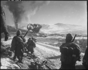 US forces in the icy conditions of Korea witness a large detonation.