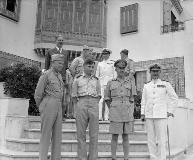 The Allied commanders of the campaign photographed in Tunisia. Front row, left to right: The Commander-in-Chief, General Dwight Eisenhower, The Air Commander-in-Chief, Mediterranean Air Command, Air Chief Marshal Sir Arthur Tedder; the Deputy Commander-in-Chief and Ground Forces Commander, General Alexander and the Naval Commander-in-Chief, Mediterranean, Admiral of the Fleet, Sir Andrew Cunningham. In the back row are the Hon. Harold MacMillian MP, Brigadier General W B Smith and Air Vice Marshal H E P Wigglesworth (on the extreme right).[© IWM (CNA 1075)]