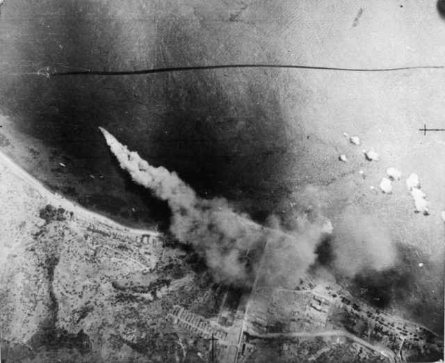 The successful German rear guard action towards the end of the campaign enabled over 100,00 Axis troops and a large quantity of equipment to be evacuated to Italy from Messina. An aerial photograph shows one of the last German ships to leave Messina on fire after being bombed by the Royal Air Force off the Sicilian coast. [© IWM (C 3733)]