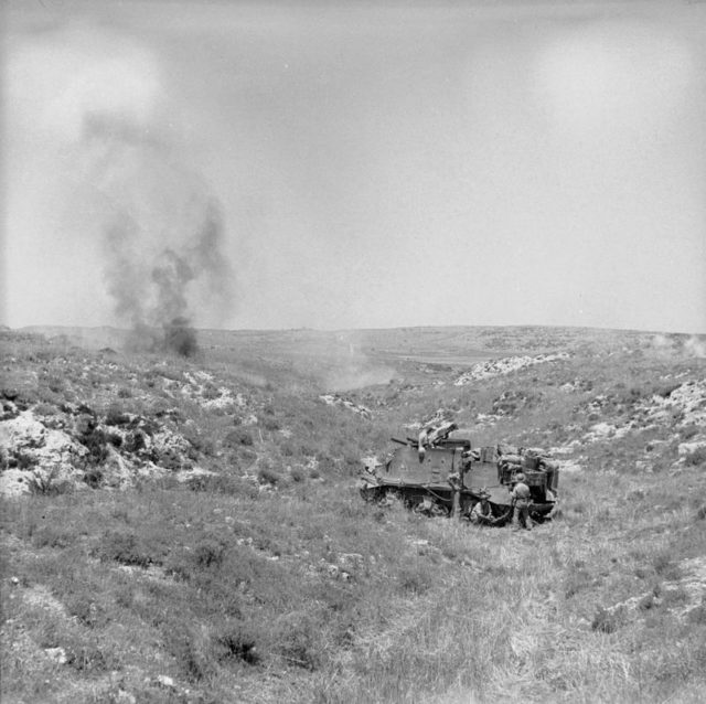 A British self propelled ‘Priest’ gun in action against the town of Palazzolo. The ‘Priest’ was a 105mm Howitzer mounted on an American M7 Howitzer Motor Carriage and was first used at the Battle of El Alamein in October 1942. [© IWM (NA 4469)]